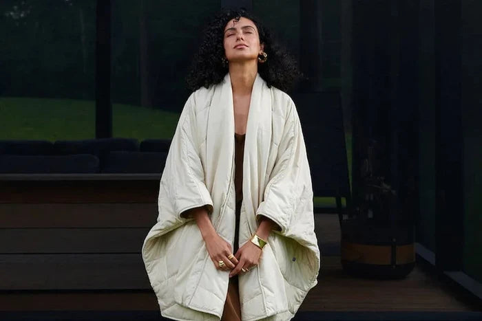 A person wearing the Snoozewear Blanket Robe, white