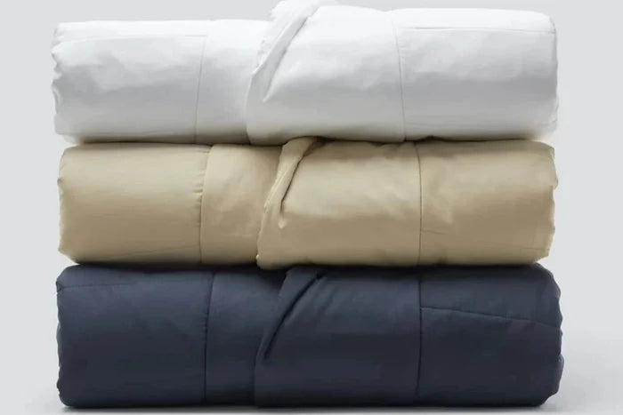Three Snoozewear Blanket Robes, different colors, folded and stacked on top of each other