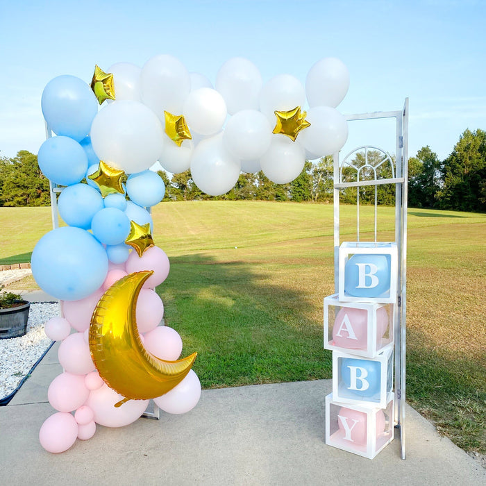 Blue and white balloon garland with gold star balloons on an outdoor path