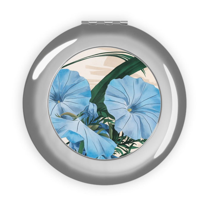 Silver compact travel mirror with round floral design inset, glossy finish