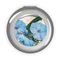 Silver compact travel mirror with round floral design inset, glossy finish