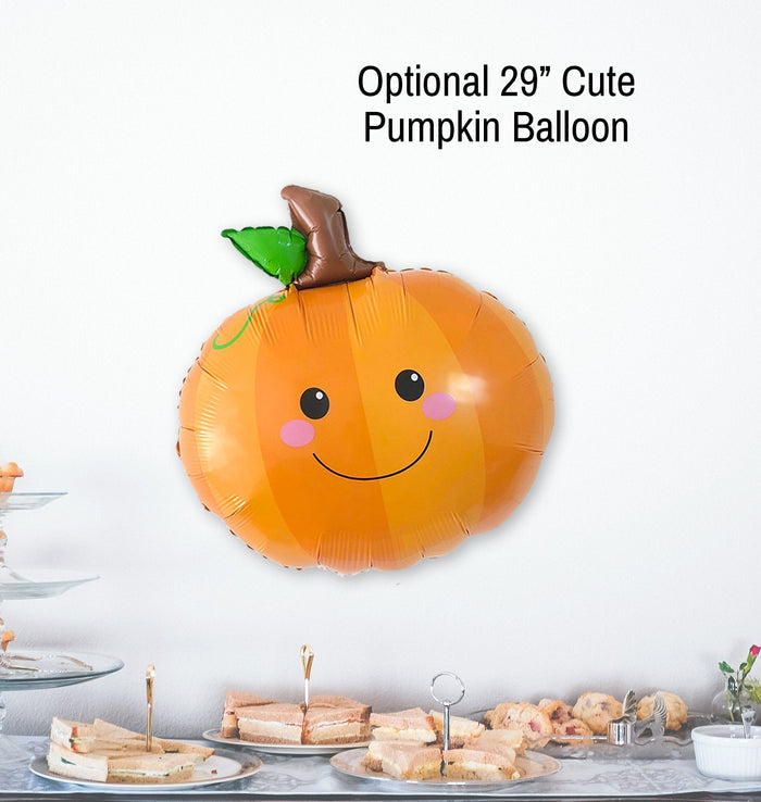 Orange pumpkin-shaped balloon with smiling face and small brown leaf hat