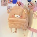 Light tan plush bear backpack with stitched face, front pocket, and small ear details