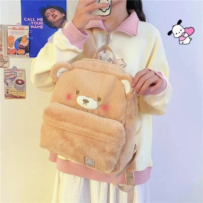 Light tan plush bear backpack with zipper top and front pocket, bear face on flap