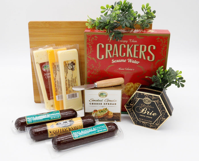 Wooden cutting board gift set with crackers, cheese spread, and packaged cheese slices