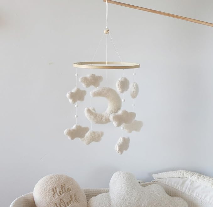 Crib moon mobile with white plush moon and cloud pieces hanging from wooden ring