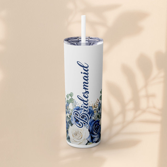 White skinny tumbler with blue and white floral design, script custom name, and light blue straw.