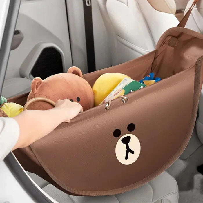 Brown car seat storage hammock with bear emblem and plush toys inside