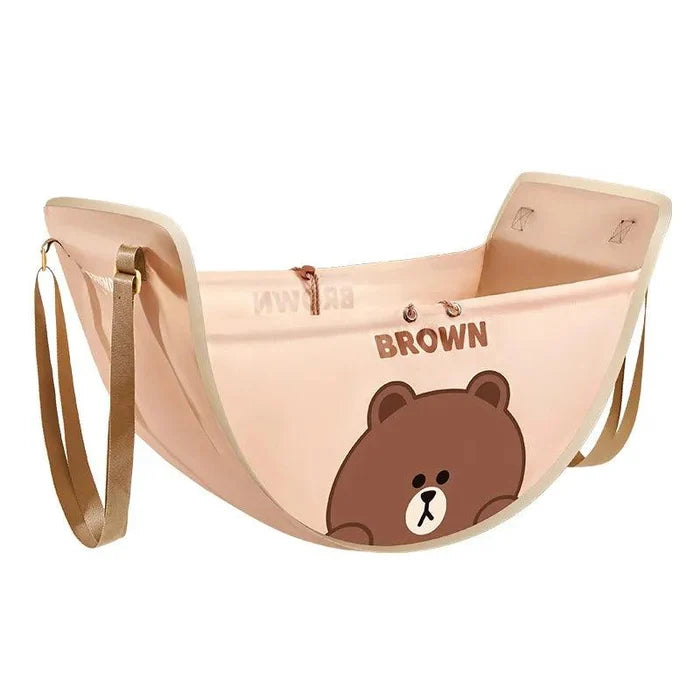 Light brown car seat storage bag with bear illustration and side strap handles