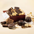 Bakery gift assortment with dark chocolate brownies and assorted cake pieces in a box