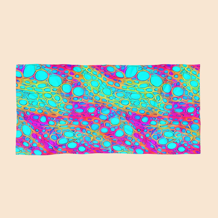 Colorful beach towel with bubble pattern in teal, turquoise, pink, and purple