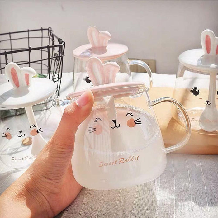 Glass bunny mug with clear body, bunny-ear lid, handle, and cute face print