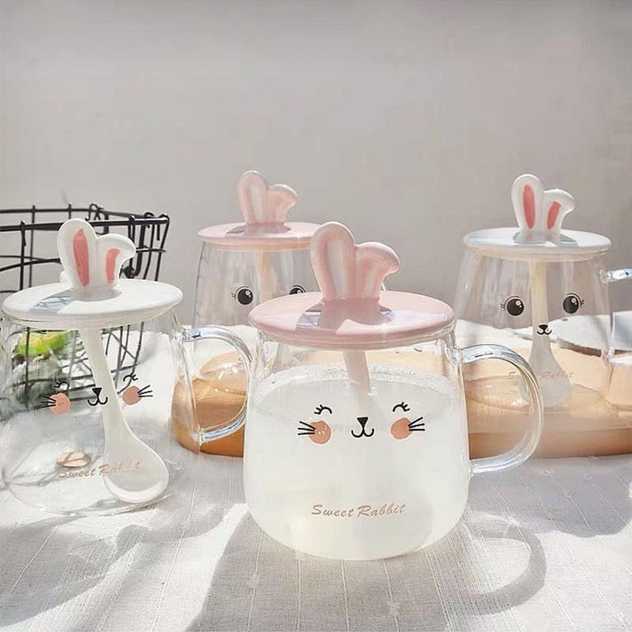 Set of clear glass bunny mugs with pink-ear lids, bunny face print, and handles