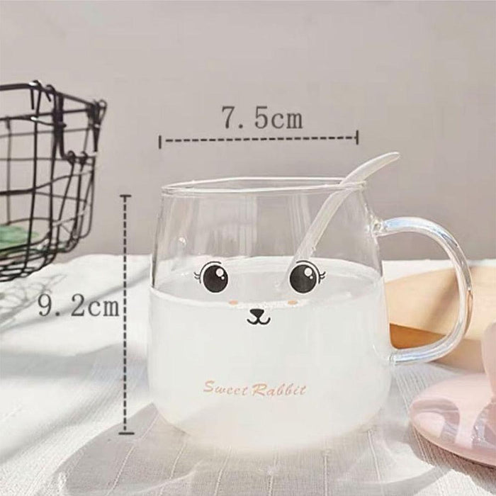 Clear glass bunny mug with bunny-face print, handle, and bunny-ear lid with spoon
