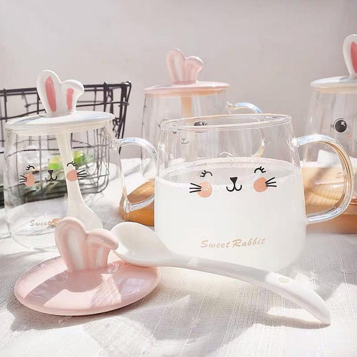 Glass bunny mug with bunny-ear lid, face print, and matching spoon rest with ears