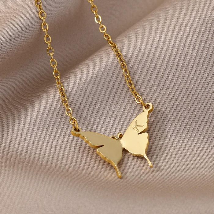 Gold-tone butterfly initial letter necklace with butterfly charms and letter K