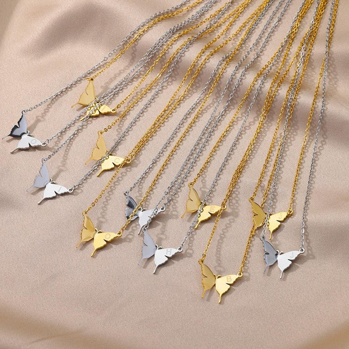 Assorted butterfly initial letter necklaces in gold and silver tones, multiple charms