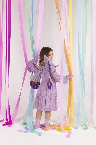 Purple butterfly wings wearable balloon costume on a child, with ribbon straps at the back