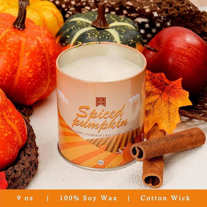 Spiced pumpkin scented soy candle jar with cotton wick, orange label, cinnamon sticks and pumpkins