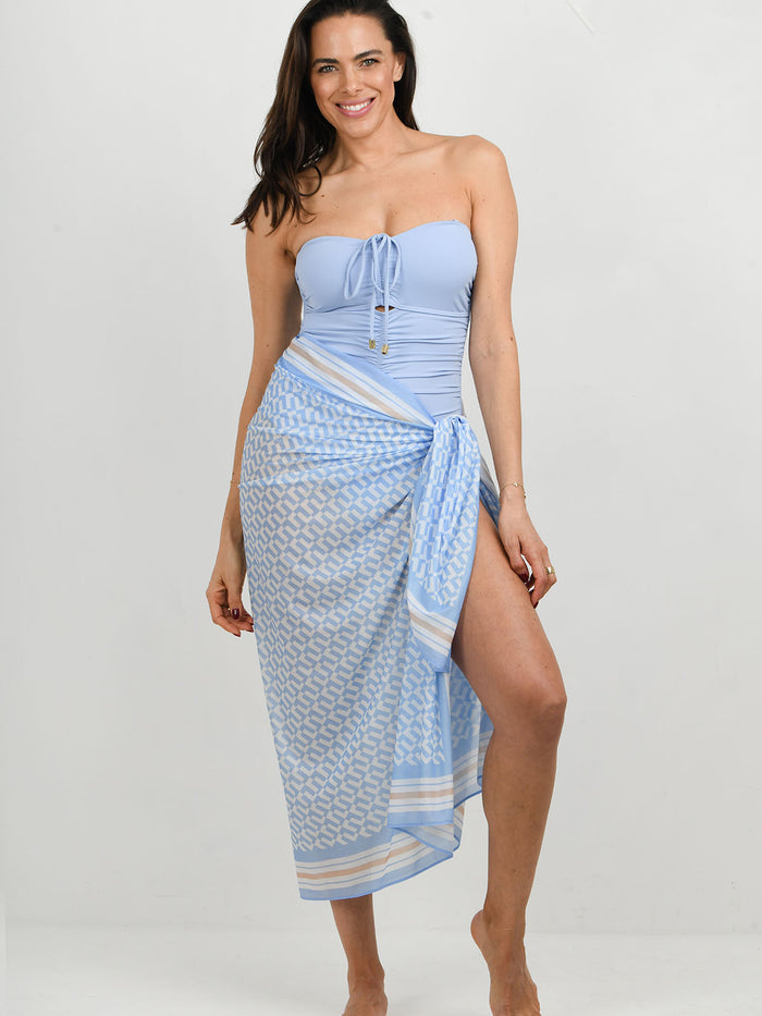 model wearing Cannes swimsuit in Blue lagoon with blue geo print sarong   by NAIA Beach