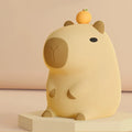 Capybara night light with orange-capped head, oval face and rounded ears