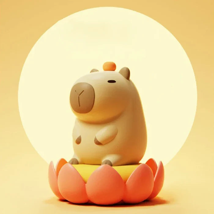 Glowing capybara night light sitting on a flower-like base