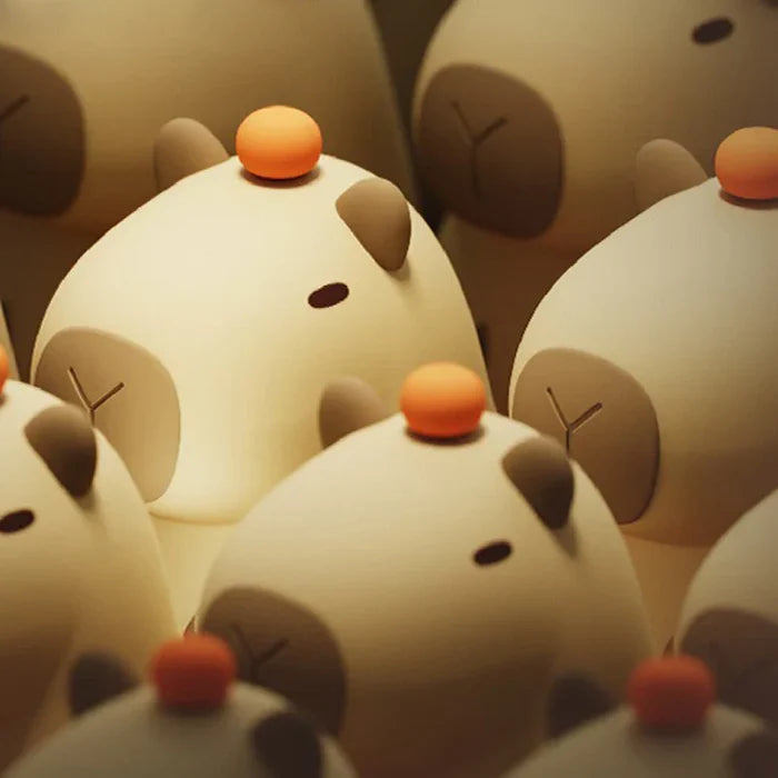 Cluster of capybara night lights with orange-capped heads and brown snout details
