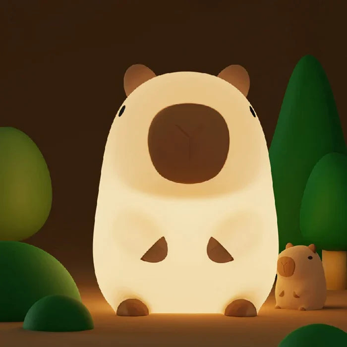 Capybara night light standing in a dark scene with green tree shapes