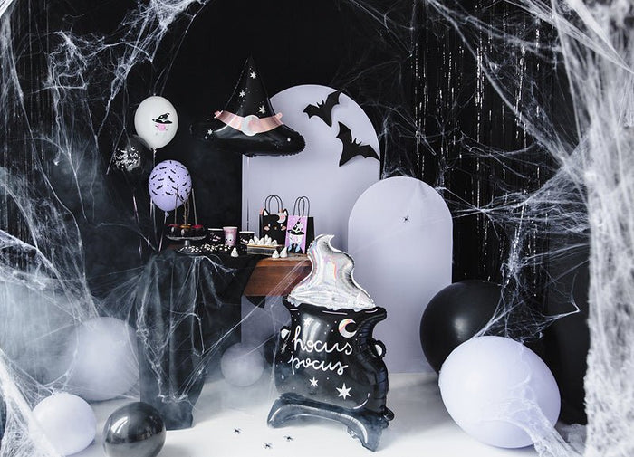 Halloween cauldron foil balloon with bats, surrounded by white and black balloons