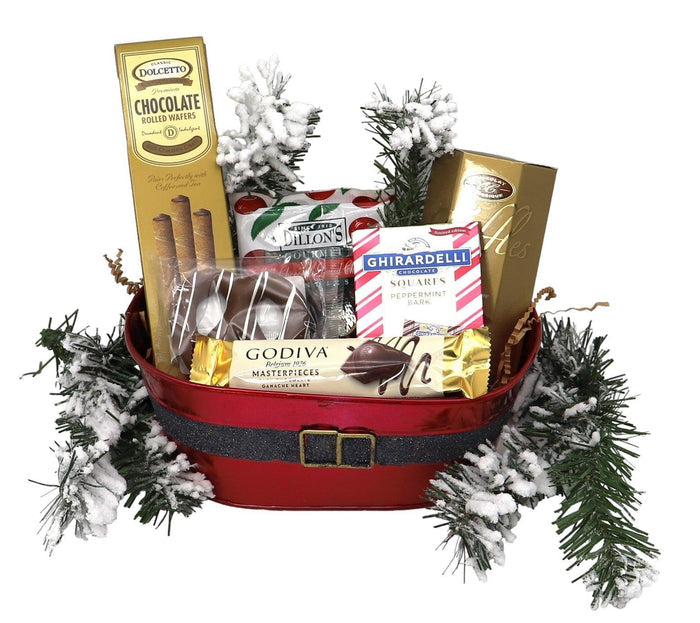 Red holiday gift basket with faux pine, assorted chocolate bars and candy packs