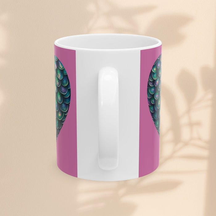 White ceramic mug with purple sides and green mermaid scale patterns