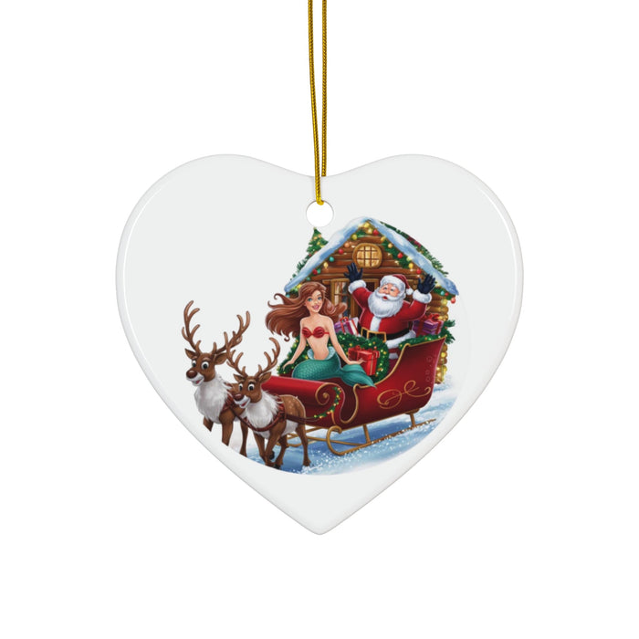 Heart-shaped ceramic ornament with mermaid and Santa riding a reindeer sleigh, hanging loop