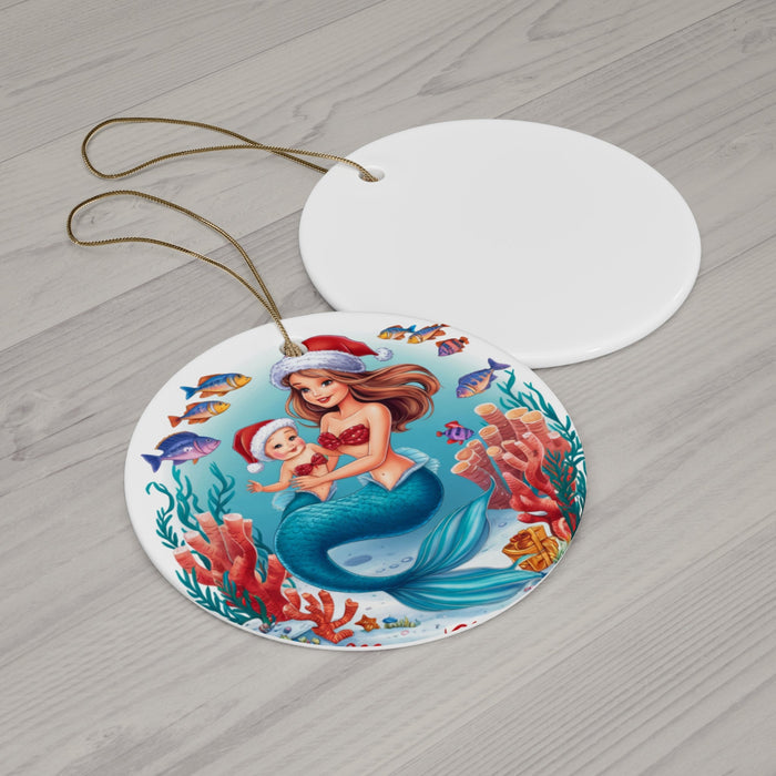 Round ceramic ornament lying down, mermaid-and-baby illustration, with gold hanging cord.