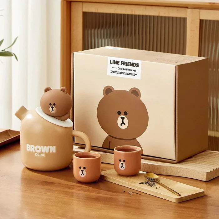 Ceramic teddy bear teapot set with box, teapot and two brown cups featuring bear face.