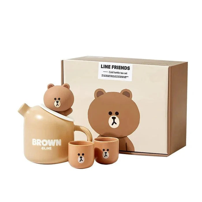 Ceramic teddy bear teapot set with box, teapot and three brown cups with bear face emblems.
