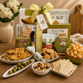 Charcuterie gift basket with crackers, olives, brie, and striped ribbon on wooden board