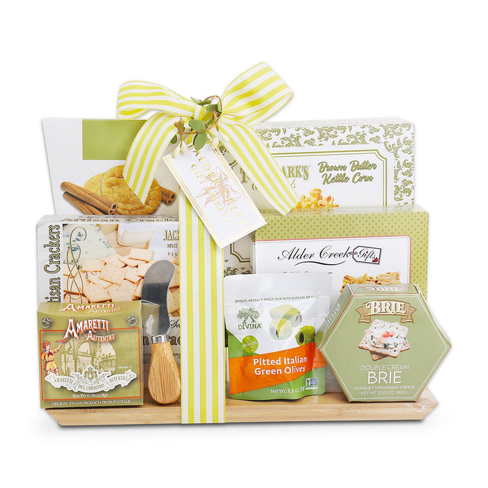 Assorted charcuterie gift basket with crackers, olives, brie, and wooden board base