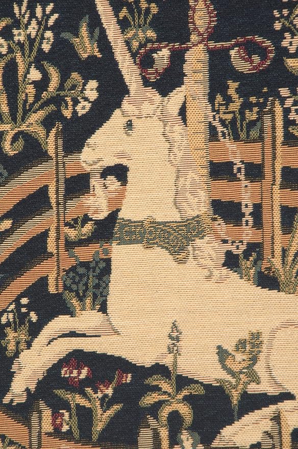 Close-up navy jacquard pillow cover with unicorn head, saddle, and vines