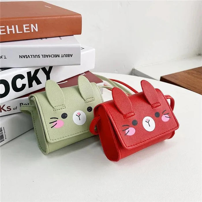 Light green and red bunny crossbody bags with stitched faces and short flap