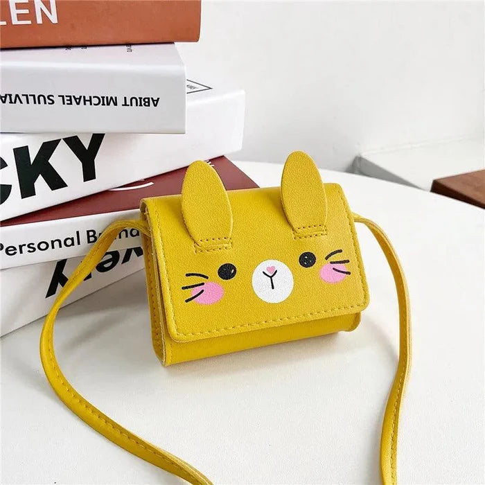Yellow bunny crossbody bag with stitched face, flap ears, and long shoulder strap