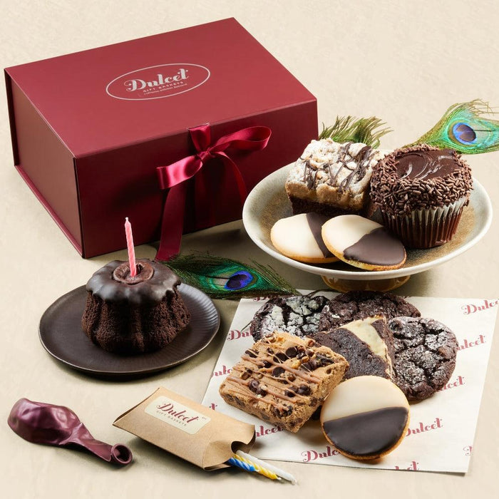 Chocolate gift basket with red ribbon, cupcakes, cookies, and brownies on a serving tray