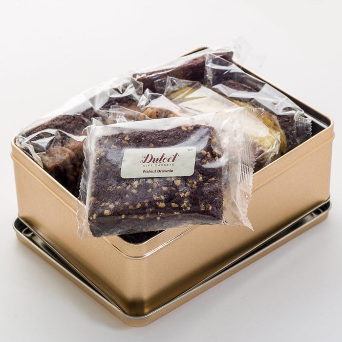 Brownie assortment in open metal tin with wrapped chocolate slices