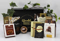 Chocolate gift box with assorted cookies and caramels in a black tray