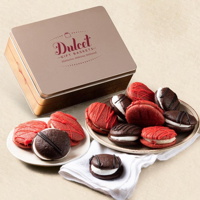 Gift tin with red velvet and chocolate whoopie pies on plates and napkin