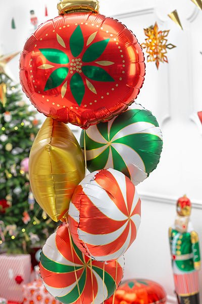 Christmas candy foil balloons close-up with red, green, and white peppermint patterns