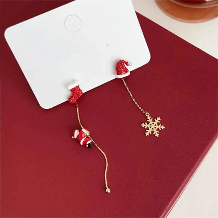 Christmas drop earrings with red heart studs and snowflake charm on chain dangles.