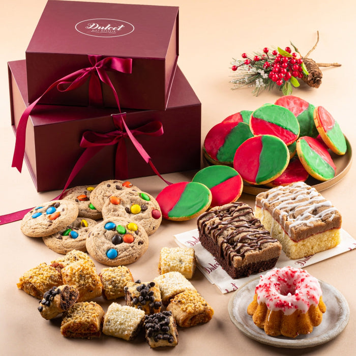 Christmas sampler gift tower with open box of assorted cookies, brownies, and pastries