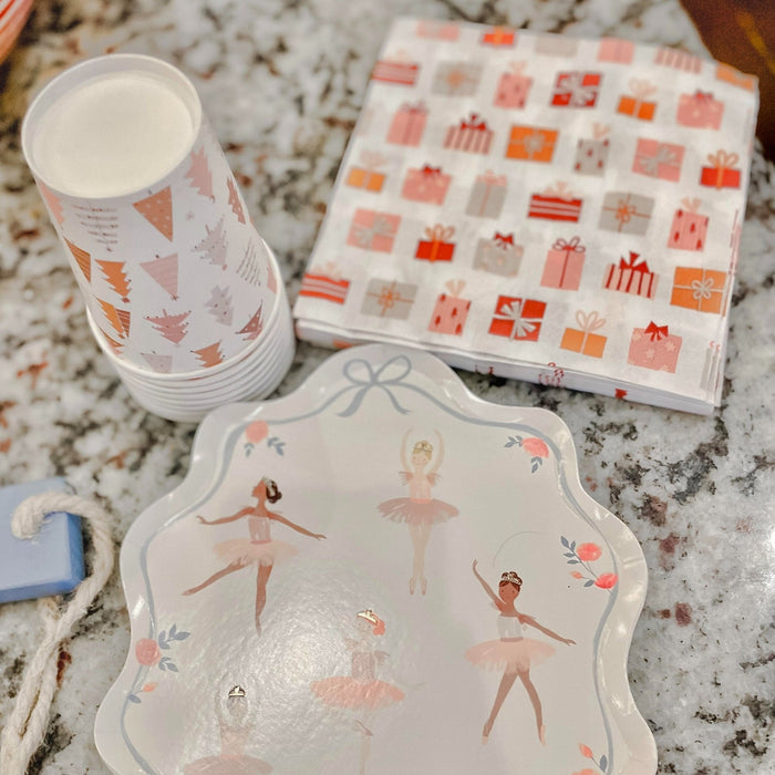 Stack of Christmas-themed paper cups with tree, ornament, and candy icons