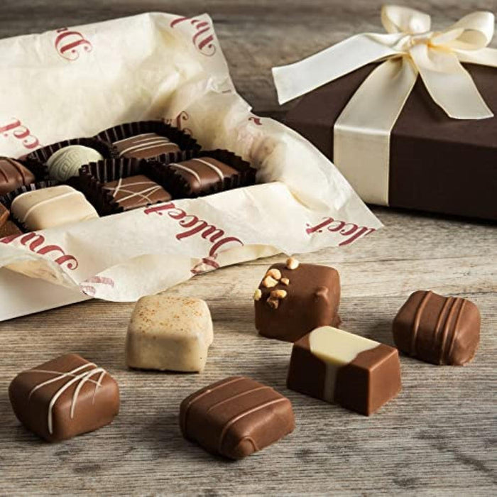 Assorted chocolate gift box with wrapped truffles and a dark chocolate bar