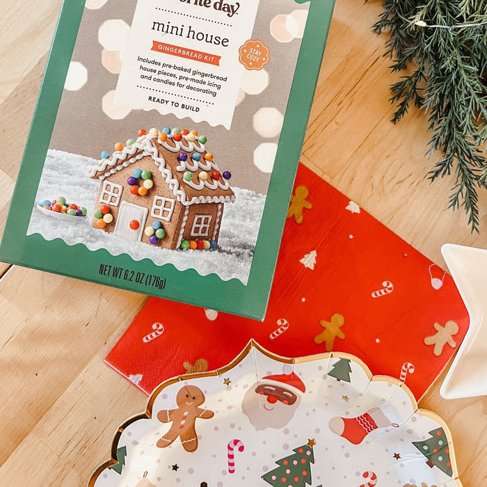 Christmas icon plates with red back and white pattern, shown on wood tabletop near building kit
